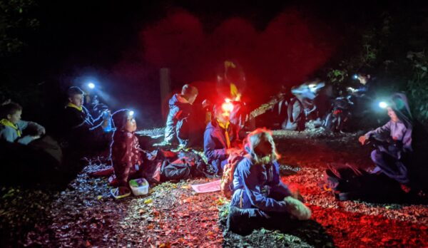 A group of scouts on a night navigation exercise stopped for a break